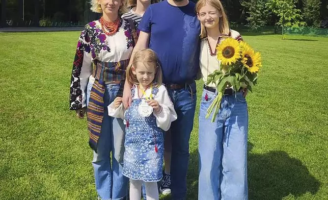 In this undated photo provided by the Lviv City Hall Press Office, Yaroslav Bazylevych poses for a photo with his family - wife Yevgenia, and their three daughters - Darina, 18, Emilia, 7, and Yaryna, 21, in Ukraine. Bazylevych lost his family in a Russian missile attack in the western city of Lviv, Ukraine, on Wednesday, Sept. 4, 2024. (Lviv City Hall Press Office via AP)