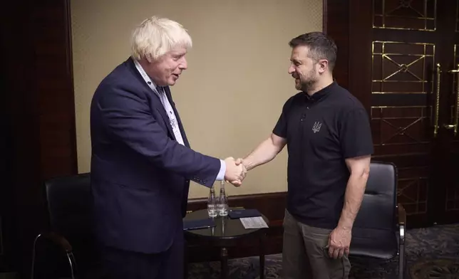 In this photo provided by the Ukrainian Presidential Press Office, Ukrainian President Volodymyr Zelenskyy, right, shakes hands with Former British Prime Minister Boris Johnson in Kyiv, Ukraine, Friday, Sept. 13, 2024. (Ukrainian Presidential Press Office via AP)