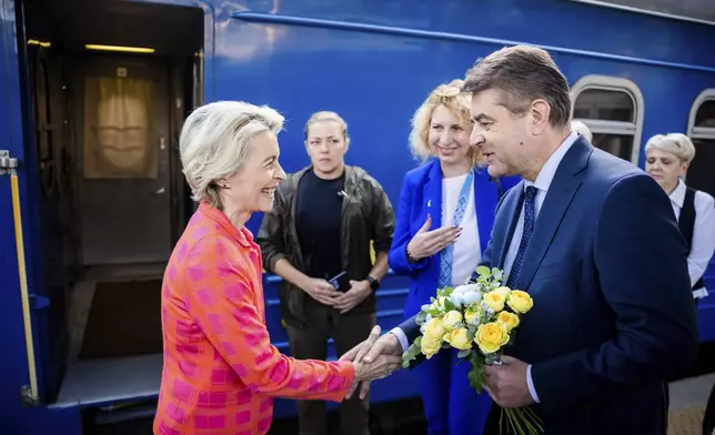 President of the European Commission, Ursula von der Leyen, left, is greeted as she arrives at the railway station in Kyiv, Ukraine, Friday, Sept. 20, 2024. (Christoph Soeder, Pool via AP)