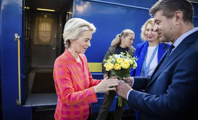 President of the European Commission, Ursula von der Leyen, left, is greeted as she arrives at the railway station in Kyiv, Ukraine, Friday, Sept. 20, 2024. (Christoph Soeder, Pool via AP)