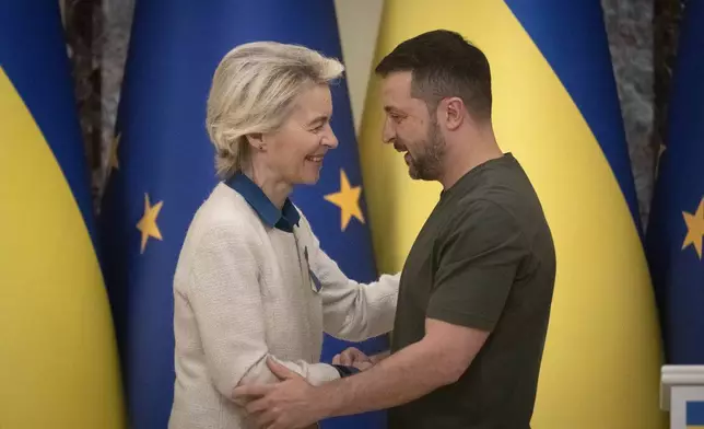 Ukrainian President Volodymyr Zelenskyy, right, and European Commission President Ursula von der Leyen greet each other in Kyiv, Ukraine, Friday, Sept. 20, 2024. (AP Photo/Efrem Lukatsky)