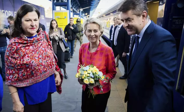 President of the European Commission, Ursula von der Leyen, center, is greeted as she arrives at the railway station in Kyiv, Ukraine, Friday, Sept. 20, 2024. (Christoph Soeder, Pool via AP)