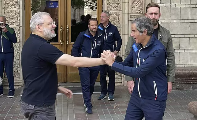 Director General of the International Atomic Energy Agency (IAEA), Rafael Mariano Grossi, right, and Ukrainian Energy Minister Herman Halushchenko shake hands in Kyiv, Ukraine, Tuesday, Sept. 3, 2024. (AP Photo/Derek Gatopoulos)