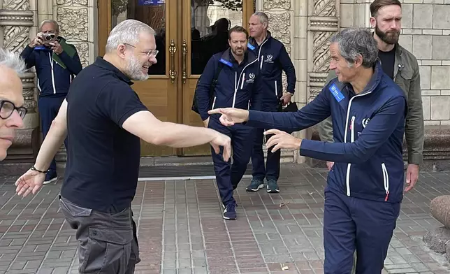 Director General of the International Atomic Energy Agency (IAEA), Rafael Mariano Grossi, right, and Ukrainian Energy Minister Herman Halushchenko greet each other in Kyiv, Ukraine, Tuesday, Sept. 3, 2024. (AP Photo/Derek Gatopoulos)