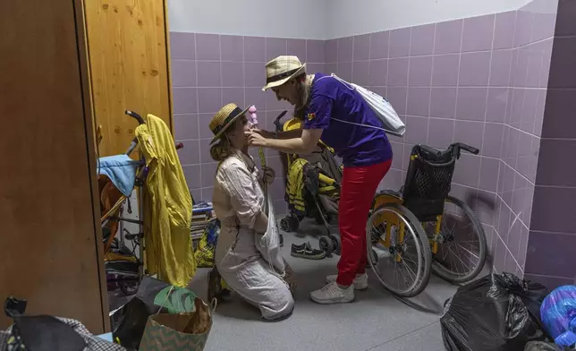 Vladyslava Kulinich, right, Tetiana Nosova, who have the clown names Lala and Zhuzha, prepare to perform at Okhmatdyt children's hospital in Kyiv, Ukraine, Thursday Sept. 19, 2024. (AP Photo/Anton Shtuka)