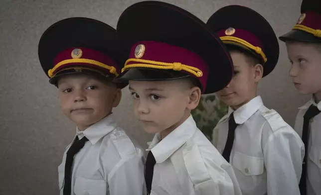 Young cadets get ready for a ceremony in a cadet lyceum on the first day at school in Kyiv, Ukraine, Monday, Sept. 2, 2024. Children and students went to school despite the fact that Kyiv was hit by massive Russian missile barrage early in the morning, causing fires, damaged buildings and infrastructure objects. (AP Photo/Efrem Lukatsky)