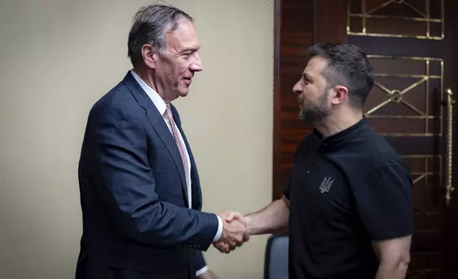 In this photo provided by the Ukrainian Presidential Press Office, Ukrainian President Volodymyr Zelenskyy, right, shakes hands with Former U.S. Secretary of State Mike Pompeo in Kyiv, Ukraine, Friday, Sept. 13, 2024. (Ukrainian Presidential Press Office via AP)