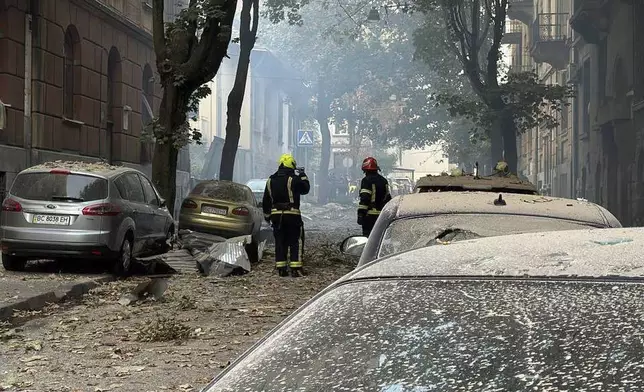 In this photo provided by the Lviv City Council, firefighters work near a residential building damaged by a Russian strike in Lviv, Ukraine, Wednesday, Sept. 4, 2024. (Lviv City Council via AP)