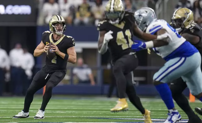 New Orleans Saints quarterback Derek Carr looks to pass against the Dallas Cowboys during the first half of an NFL football game, Sunday, Sept. 15, 2024, in Arlington, Texas. (AP Photo/Jeffrey McWhorter)