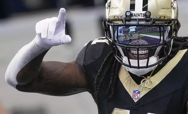 New Orleans Saints running back Alvin Kamara reacts after scoring a long touchdown run against the Dallas Cowboys during the first half of an NFL football game, Sunday, Sept. 15, 2024, in Arlington, Texas. (AP Photo/Tony Gutierrez)