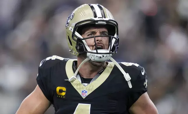 New Orleans Saints quarterback Derek Carr reacts after throwing a touchdown pass to wide receiver Rashid Shaheed during the first half of an NFL football game against the Dallas Cowboys, Sunday, Sept. 15, 2024, in Arlington, Texas. (AP Photo/Tony Gutierrez)