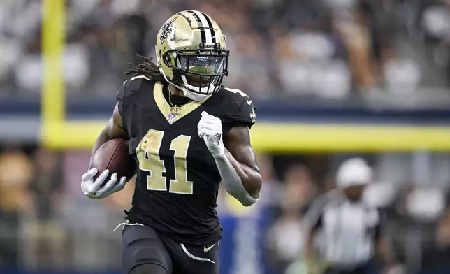 New Orleans Saints running back Alvin Kamara breaks away for a long touchdown run against the Dallas Cowboys during the first half of an NFL football game, Sunday, Sept. 15, 2024, in Arlington, Texas. (AP Photo/Tony Gutierrez)