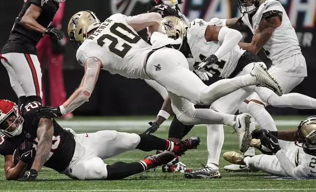 Atlanta Falcons running back Tyler Allgeier (25) runs against New Orleans Saints linebacker Pete Werner (20) during the second half of an NFL football game, Sunday, Sept. 29, 2024, in Atlanta. (AP Photo/John Bazemore)