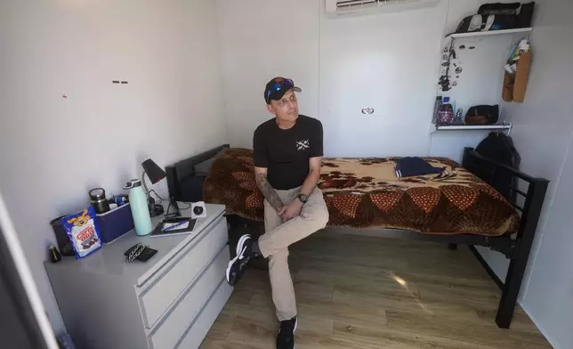 Steven Burcell is interviewed in his room at the Five Keys' Mission Cabins transitional housing location in San Francisco, Monday, Aug. 26, 2024. (AP Photo/Jeff Chiu)