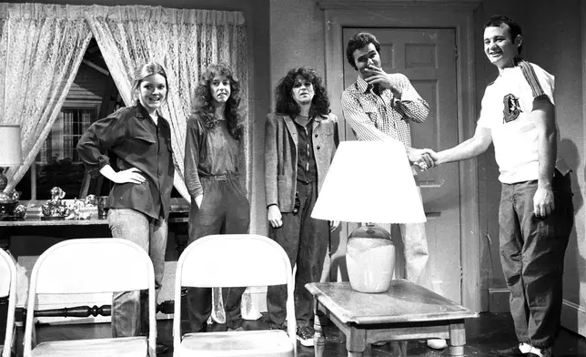 FILE - Actor Burt Reynolds, second right, appears on the set with cast members of NBC's "Saturday Night Live," from left, Jane Curtin, Laraine Newman, Gilda Radner, and Bill Murray, right, in New York, April 12, 1980. (AP Photo/Suzanne Vlamis, File)