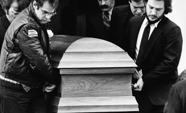 FILE - The coffin for actor John Belushi is carried out of the Congregational Church by pallbearers Dan Aykroyd, left, and Belushi's brother Jim Belushi, right, following funeral services in West Tinsbury, Mass., on March 9, 1982. Belushi died March 5, at 33 after overdosing at the Chateau Marmont in Los Angeles. (AP Photo/Dave Tenenbaum, File)