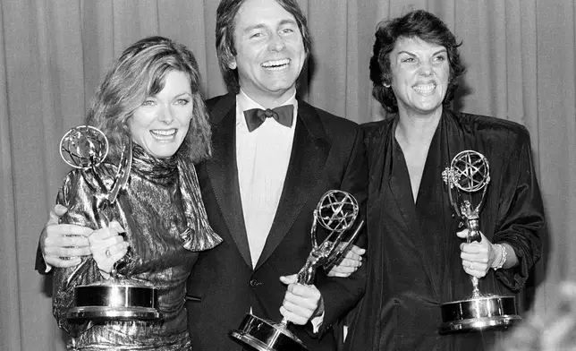 FILE - Emmy winners, from left, Jane Curtin, John Ritter, and Tyne Daly pose backstage at the Emmy Awards presentation at the Pasadena Civic Auditorium in Pasadena, Ca., Sept. 23, 1984. Curtin won for best actress in a comedy series for "Kate and Allie"; Ritter was named outstanding actor in a comedy series for his role in "Three's Company"; and Daly won for best actress in a dramatic series for "Cagney and Lacey." (AP Photo, File)