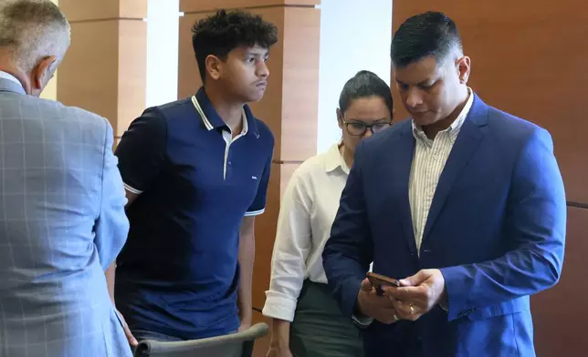 Anthony Borges and his parents exit court on Thursday, Sept. 5, 2024, in Broward County, Fla. Borges was shot five times in the mass shooting at Marjory Stoneman Douglas High School on Valentine's Day 2018. The families of the Parkland victims are in court to debate whether one plaintiff, the family of Anthony Borges, has the right to unilaterally negotiate a settlement entitling him to the rights to Nikolas Cruz's name and inheritance. (Mike Stocker/South Florida Sun-Sentinel via AP)