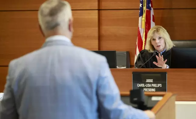 Judge Carol-Lisa Phillips' speaks to Anthony Borges' attorney, Alex Arreaza in her Broward County, Fla., Courtroom on Thursday, Sept. 5, 2024. Borges was shot five times in the mass shooting at Marjory Stoneman Douglas High School on Valentine's Day 2018. The families of the Parkland victims are in court to debate whether one plaintiff, the family of Anthony Borges, has the right to unilaterally negotiate a settlement entitling him to the rights to Nikolas Cruz's name and inheritance. (Mike Stocker /South Florida Sun-Sentinel via AP)