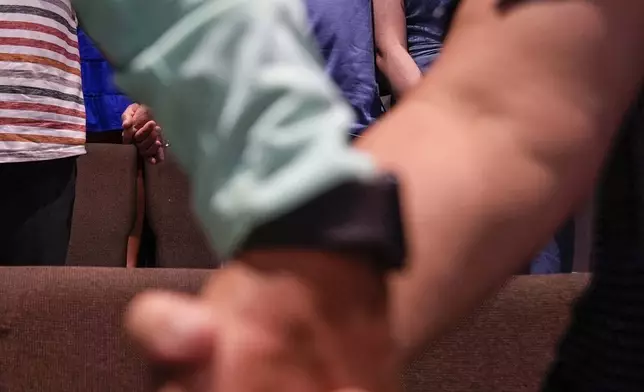 Church members pray during a Sunday service at Bethlehem Church, Sunday, Sept. 8, 2024, in Bethlehem, Ga. Colt Gray, 14, has been charged with murder over the killing of two students and two teachers at Apalachee High School in Barrow County, outside Atlanta, on Wednesday. (AP Photo/Mike Stewart)