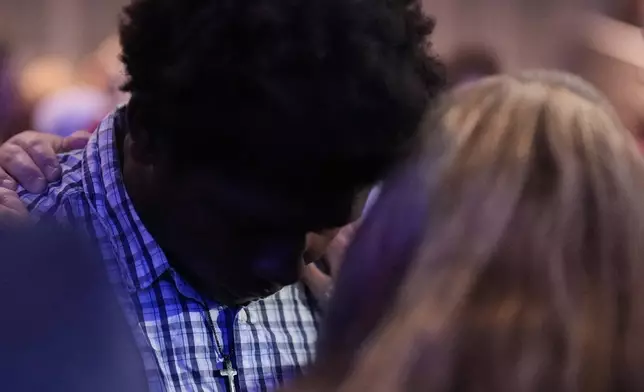 An Apalachee High School student, left, is embraced during a Sunday service at Bethlehem Church, Sunday, Sept. 8, 2024, in Bethlehem, Ga. Colt Gray, 14, has been charged with murder over the killing of two students and two teachers at Apalachee High School in Barrow County, outside Atlanta, on Wednesday. (AP Photo/Mike Stewart)