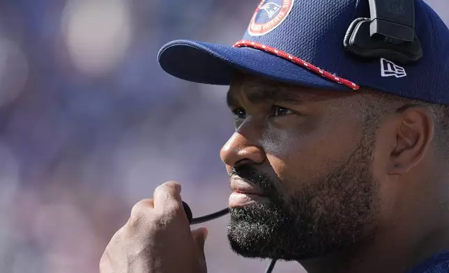 New England Patriots head coach Jerod Mayo adjusts his microphone in the second half of an NFL football game against the Seattle Seahawks, Sunday, Sept. 15, 2024, in Foxborough, Mass. (AP Photo/Michael Dwyer)