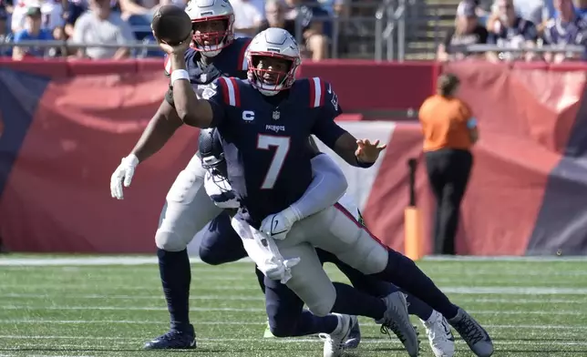 New England Patriots quarterback Jacoby Brissett (7) is brought down by Seattle Seahawks linebacker Boye Mafe, center, in the second half of an NFL football game, Sunday, Sept. 15, 2024, in Foxborough, Mass. (AP Photo/Michael Dwyer)