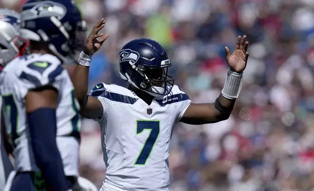 Seattle Seahawks quarterback Geno Smith (7) celebrates after running back Zach Charbonnet rushed for a touchdown in the first half of an NFL football game against the New England Patriots, Sunday, Sept. 15, 2024, in Foxborough, Mass. (AP Photo/Charles Krupa)