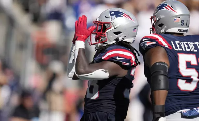 New England Patriots running back Rhamondre Stevenson, left, celebrates his touchdown in front of guard Nick Leverett, right, in the second half of an NFL football game against the Seattle Seahawks, Sunday, Sept. 15, 2024, in Foxborough, Mass. (AP Photo/Charles Krupa)