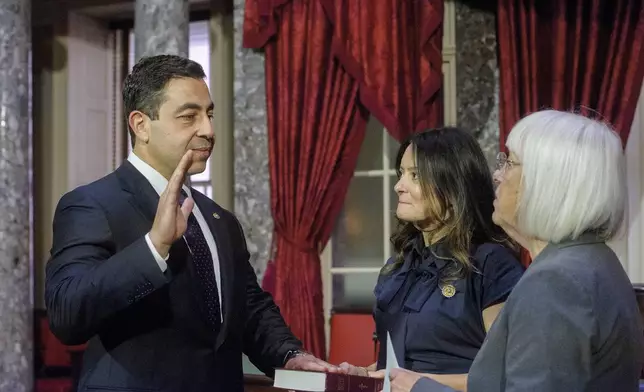 Sen. Patty Murray, D-Wash., right, administers the oath of office to Sen. George Helmy, D-N.J., left, as his wife Caroline Helmy holds the Bible during a re-enactment swearing-in, in the Old Senate Chamber at the Capitol in Washington, Monday, Sept. 9, 2024. (AP Photo/Rod Lamkey, Jr.)