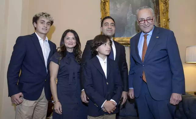 Senator-designee George Helmy, D-N.J., second from right, poses with his wife Caroline Helmy, second from left, and his sons Joshua, 15, left, and Elijah, 12, third from left, and Senate Majority Leader Chuck Schumer, D-N.Y., right, prior to taking the oath of office in the Old Senate Chamber at the Capitol in Washington, Monday, Sept. 9, 2024. (AP Photo/Rod Lamkey, Jr.)