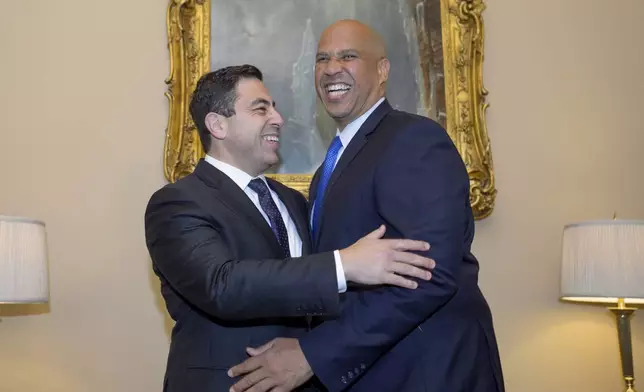 Senator-designee George Helmy, D-N.J., left, meets with Sen. Cory Booker, D-N.J., prior to taking the oath of office in the Old Senate Chamber at the Capitol in Washington, Monday, Sept. 9, 2024. (AP Photo/Rod Lamkey, Jr.)