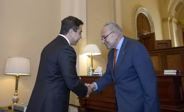 Senator-designee George Helmy, D-N.J., left, meets with Senate Majority Leader Chuck Schumer, D-N.Y., prior to taking the oath of office in the Old Senate Chamber at the Capitol in Washington, Monday, Sept. 9, 2024. (AP Photo/Rod Lamkey, Jr.)