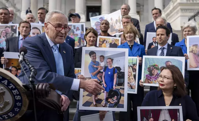 Senate Majority Leader Chuck Schumer, D-NY, left, accompanied by Sen. Tammy Duckworth, D-Ill., right, speaks about the need to protect rights to in vitro fertilization (IVF), on the Senate steps at the Capitol in Washington, Tuesday, Sept. 17, 2024. (AP Photo/Ben Curtis)