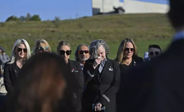 Employees of United Airlines observe a moment of silence for their coworkers who were killed aboard United Airlines flight 93, prior to the Flight 93 National Memorial's 23rd annual observance ceremony near Shanksville, Pa., Wednesday, Sept. 11, 2024. (John Rucosky/The Tribune-Democrat via AP)