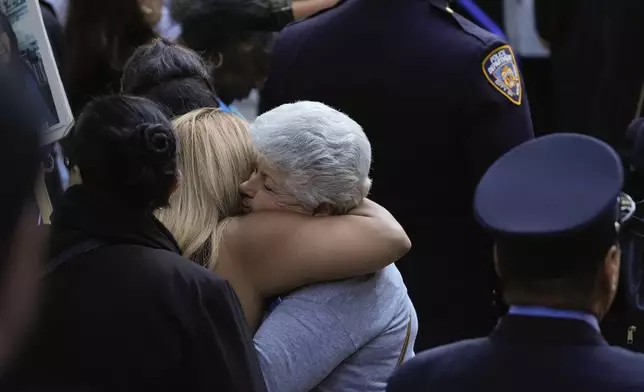 Two women hug while attending the 9/11 Memorial ceremony on the 23rd anniversary of the Sept. 11, 2001 attacks, Wednesday, Sept. 11, 2024, in New York. (AP Photo/Pamela Smith)