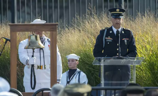 A member of the military reads the names of the victims of Sept. 11 at the Pentagon during an observance ceremony Wednesday, Sept. 11, 2024,in Washington. (AP Photo/Kevin Wolf)