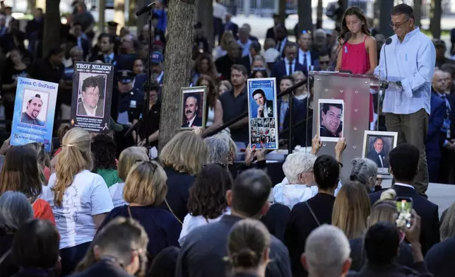 Relatives read names during a 9/11 commemoration ceremony at Ground Zero, in New York, Wednesday, Sept. 11, 2024. (AP Photo/Jacquelyn Martin)