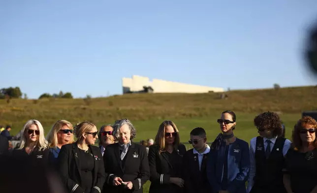 Airline employees pause at the Flight 93 National Memorial on the 23rd anniversary of the Sept. 11, attacks in Shanksville, Pa., Tuesday, Sept. 11, 2024. (AP Photo/Jared Wickerham)