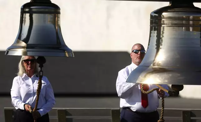 The Bells of Remembrance are rung by Fred Lukachinsky, president of Friends of Flight 93, and Donna Gibson, left, executive director of Friends of Flight 93, at the Flight 93 National Memorial on the 23rd anniversary of the Sept. 11 attacks in Shanksville, Pa., Wednesday, Sept. 11, 2024. (AP Photo/Jared Wickerham)