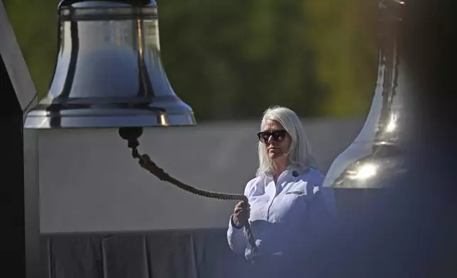 Friends of Flight 93 Executive Director Donna Gibson rings the Bells of Remembrance during the Flight 93 National Memorial's 23rd annual observance ceremony , Wednesday, Sept. 11, 2024, in Shanksville, Pa. (John Rucosky/The Tribune-Democrat via AP)