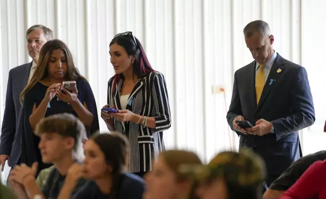Lynne Patton, Laura Loomer and Corey Lewandowski watch as Republican presidential nominee former President Donald Trump visits the Shanksville Volunteer Fire Company in Shanksville, Pa., Wednesday, Sept. 11, 2024. (AP Photo/Matt Rourke)