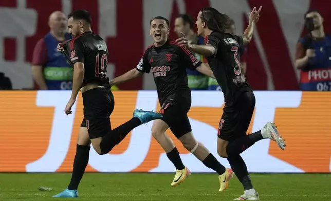 Benfica's Orkun Kokcu, left, celebrates with teammates after scoring his side's second goal during the Champions League opening phase soccer match between Red Star and SL Benfica, at the Rajko Mitic Stadium in Belgrade, Serbia, Thursday, Sept. 19, 2024. (AP Photo/Darko Vojinovic)