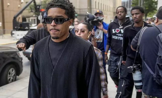 Justin Dior Combs, left, leaves Manhattan federal court after his father, Sean "Diddy" Combs, was ordered held without bail in his federal sex trafficking case, Tuesday, Sept. 17, 2024, in New York. (AP Photo/Seth Wenig)