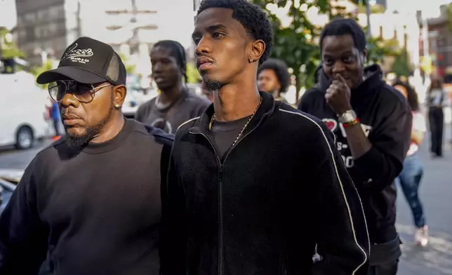 King Combs, center, leaves Manhattan federal court after his father, Sean "Diddy" Combs, was ordered held without bail in his federal sex trafficking case, Tuesday, Sept. 17, 2024, in New York. (AP Photo/Seth Wenig)