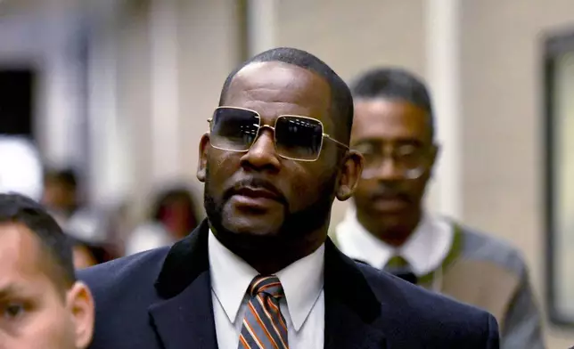 FILE - R. Kelly leaves the Daley Center after a hearing in his child support case, May 8, 2019, in Chicago. (AP Photo/Matt Marton, File)