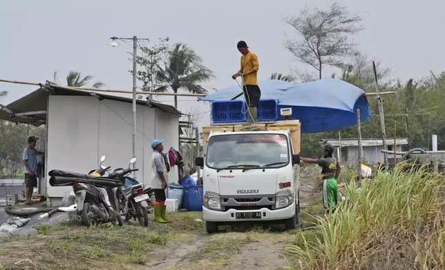 Workers prepare a truck loaded with shrimp containers at a farm in Kebumen, Centra Java, Indonesia, Tuesday, Sept. 24, 2024. (AP Photo/Dita Alangkara)