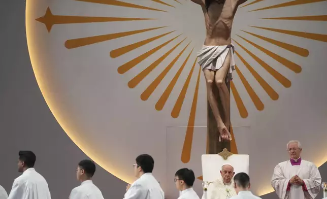 Pope Francis presides over a mass 'In Memory of the Most Holy Name of Mary' celebrated by the Archbishop of Singapore, Cardinal William Goh Seng Chye at the Singapore SportsHub National Stadium, Thursday, Sept. 12, 2024. Pope Francis has praised Singapore's economic development as a testament to human ingenuity. But he's urging the city-state to look after the weakest too. Francis made the remarks Thursday on the final leg of the longest and farthest tour of his papacy. (AP Photo/Gregorio Borgia)