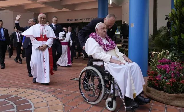 From right, Pope Francis, Archbishop of Singapore William Seng Chye Goh, and Singapore's Minister of Culture Edwin Tong attend an interreligious meeting with young people at the Catholic Junior College in Singapore, Friday, Sept. 13, 2024. Pope Francis is wrapping up his visit to Singapore by praising its tradition of interfaith harmony. (AP Photo/Gregorio Borgia)