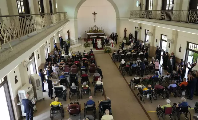 Pope Francis meets with a group of elderly and sick people at the St. Theresa's Home in Singapore, Friday, Sept. 13, 2024. Pope Francis is wrapping up his visit to Singapore by praising its tradition of interfaith harmony. (AP Photo/Gregorio Borgia)